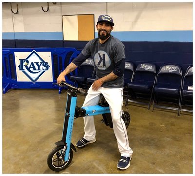 Tampa Bay Rays Pitcher Sergio Romo posing on his blue Go-Bike M2