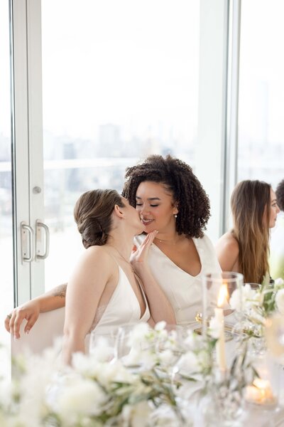 Brides At Head Table Kissing