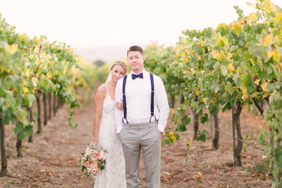 Bride stands with groom at Firestone Winery wedding