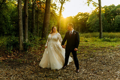 married couple walking at sunset holding hands
