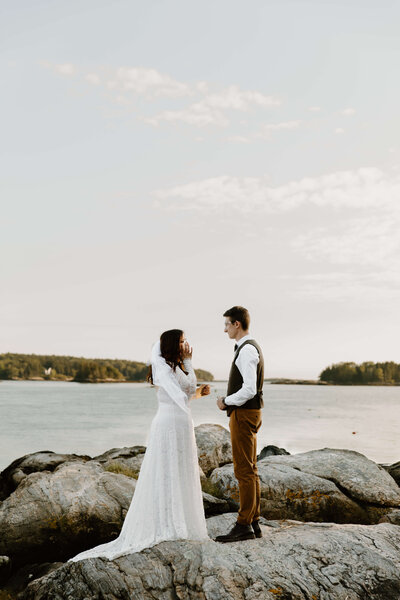 Bride wiping her tears during vow renewal in Boothbay Harbor, Maine