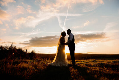 A newly married couple on the moor in Haworth at Sunset