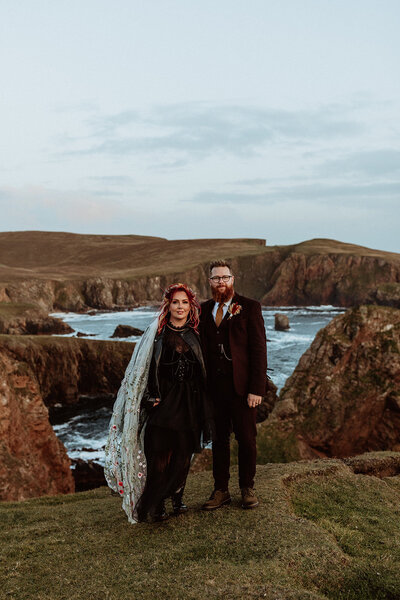 bride and groom walking infront of waterfall