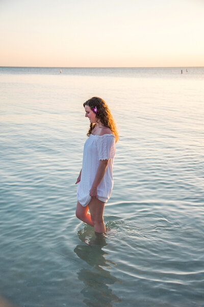 Girl walking in the ocean in Fort Myers