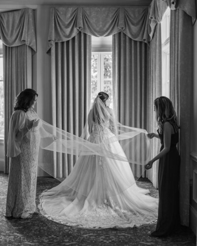 mother of the bride and maid of honor fluffing brides veil at the Ledges in Huntsville Alabama
