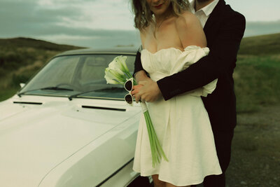 Bride and groom with classic car