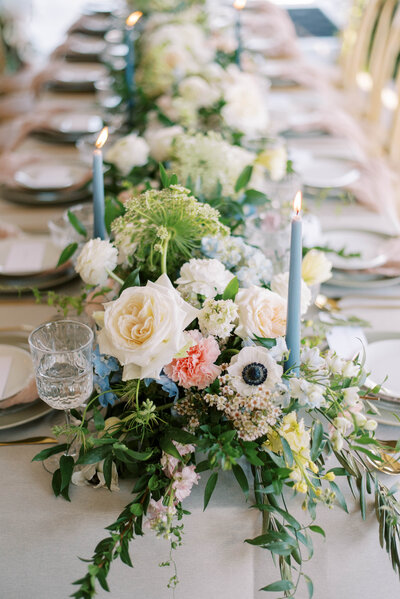 elegant table setting with a lush  line of florals and greenery for a wedding in St. Petersburg Florida