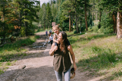 Candid of girl and mom looking at each other on a walk in Breckenridge