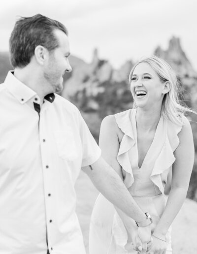 Cute woman smiles at her fiance during their engagement session in Colorado Springs.