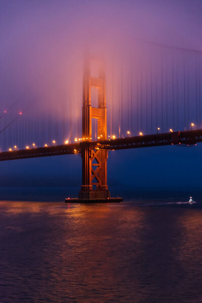 Golden Gate Bridge in fog at dawn