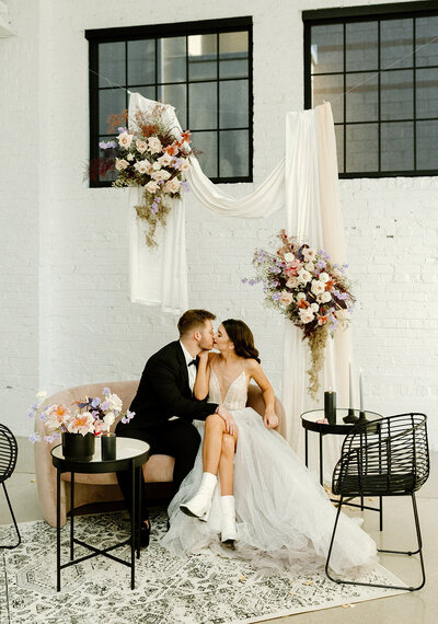 couple kissing on their lounge styled by destination wedding planner