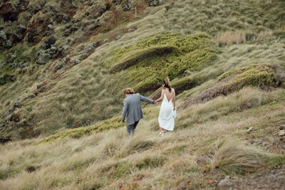 Couple walking in a grass field
