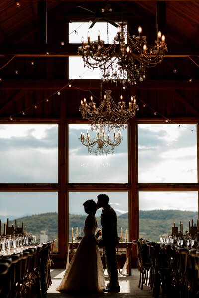 bride and groom silhouette kissing in their reception at granite ridge estate