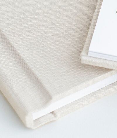 linen heirloom albums  filled with images by charlotte photographer