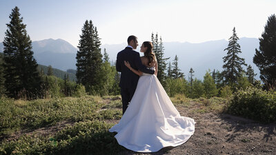 Bride and Groom gaze out over Colorado Mountains
