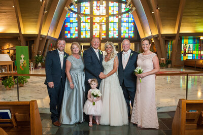 Plyler family posing for wedding photos at Saint George Church in Erie PA.