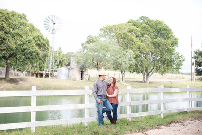engagement session  farm windmill white fence wedding venue in Boerne Texas by Firefly Photography