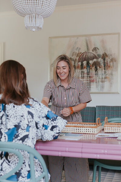 Interior designer, Hadley Quisenberry working with a client in the West Trade Interiors studio in Eastover Charlotte