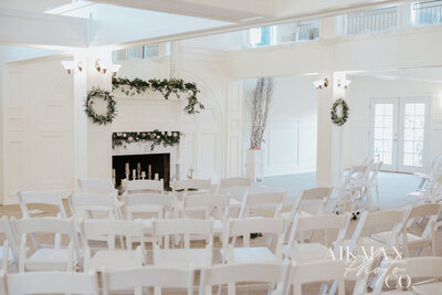 decorated fireplace with chairs in the grand room
