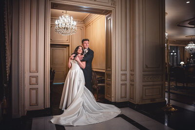 Bride and groom siting on vintage sofa at the Westgate hotel, San Diego