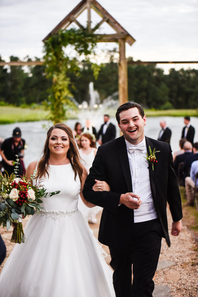 Bride and Groom walking up the aisle at Greengates Farmhouse in Laurel, MS