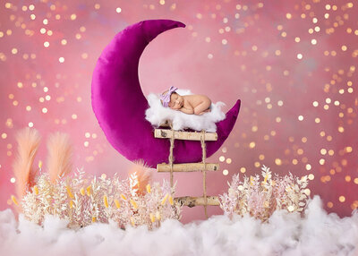 Sleeping infant on pink digital moon captured by H&N photography Denver