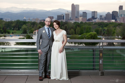 Wedding couple portrait with Denver Skyline in backdrop DMNS