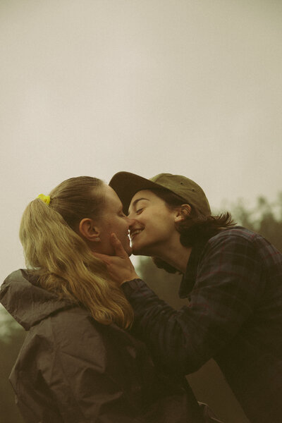 Man and woman romantically spin around, laughing in the middle of a  flowery field