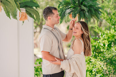An engaged couple being playful at a historic Wilmington estate enjoying their Wilmington wedding photography by JoLynn Photography
