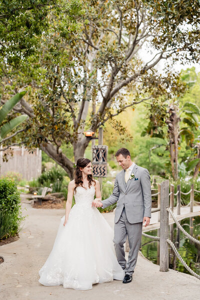 Bride and Groom walking holding hands at their wedding at San Diego Safari Park