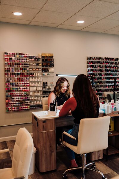 nail tech in NJ chatting with her client