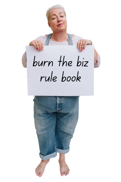 Pippa holding up a sign that reads "burn the biz rule book"