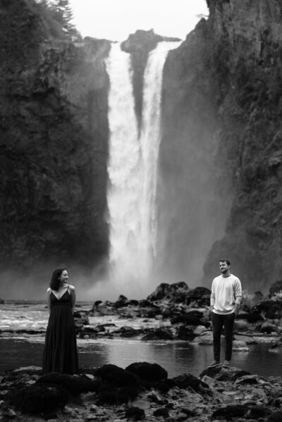 Couples standing in front of massive waterfall