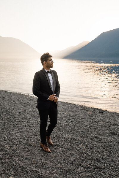 Groom stands on a lakefront nervously waiting for the bride
