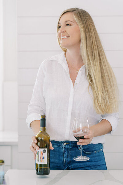 Portrait of Kelsey Halm pouring wine