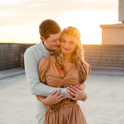 Engaged couple holding hands during the sunset at Fisher Farm in Charlotte North Carolina captured by Charlotte wedding photographer..