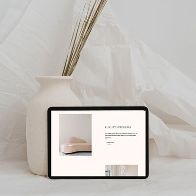 Boutique website design on an ipad with a neutral minimalist background