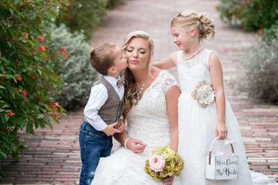 austin wedding photographer boy kisses bride on cheek flower girl austin texas