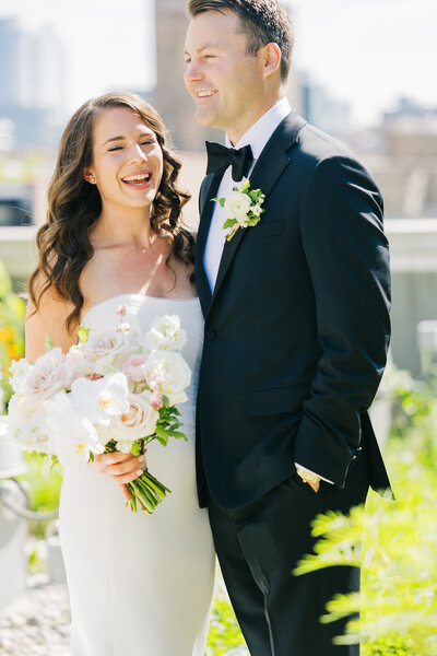 A couple candidly laughs on their wedding day in Chicago