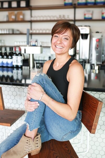woman smiling at a cafe