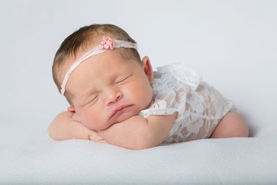Precious baby girl posed for newborn mini session