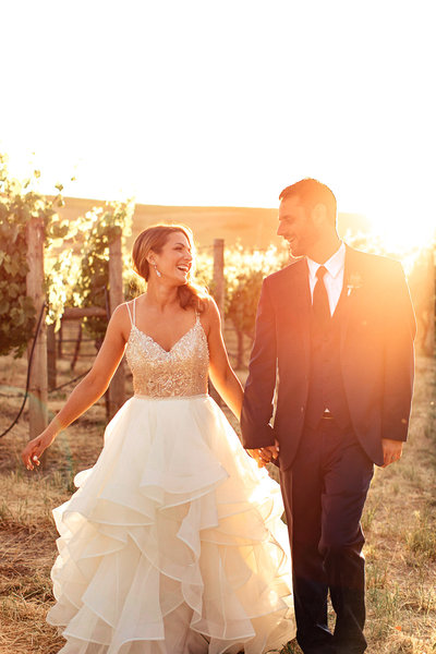 Wedding Photography, bride and groom walking in a vineyard