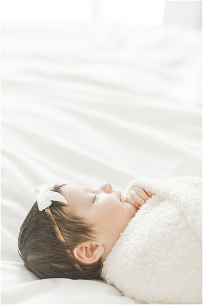 Newborn baby girl naturally posed during her newborn photo session in Maryland