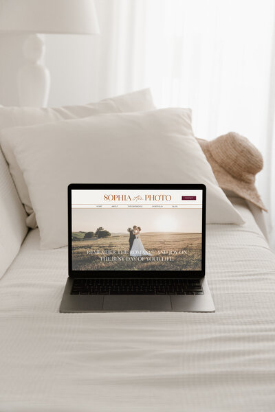 Laptop showing a classy, timeless design of a wedding photographer website
