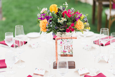outdoor wedding receptiono decor for denver wedding with bright florals as a center piece captured by denver wedding photographer