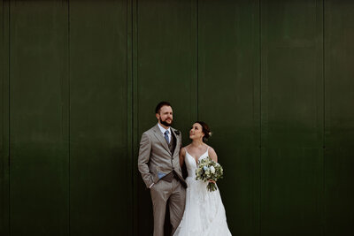Bride and groom infront of green doors