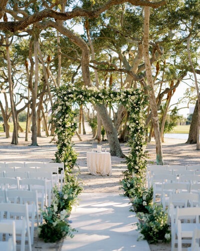 Ceremony aisle decor at Longboat Key Club wedding with green and white florals.