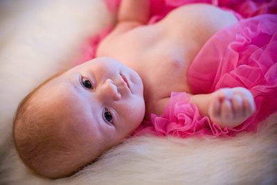 new baby watches everything intently in pink tutu