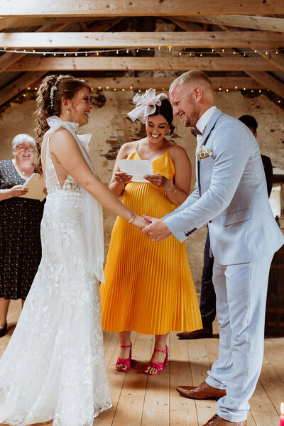 bride and groom laugh during ceremony