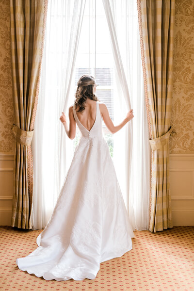 bride looking out window at Carmel Country Club Wedding